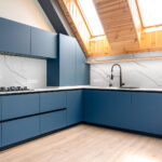 Blue minimal kitchen. Attic skylights. Bright marble